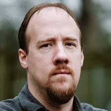 Presenting Male with reddish brown hair